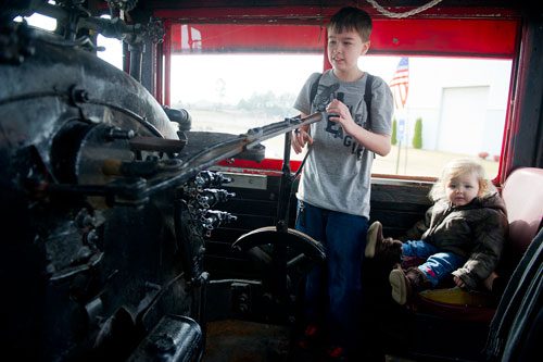 Seth Putnam (left) and his sister Eden play with the controls of a locomotive engine at the Southeastern Railway Museum in Duluth on Thursday, January 3, 2013.