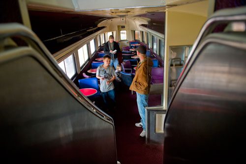 Brian Putnam (back left), his daughter Eden, son Seth and brother Andy walk through a locomotive dining car at the Southeastern Railway Museum in Duluth on Thursday, January 3, 2013. 