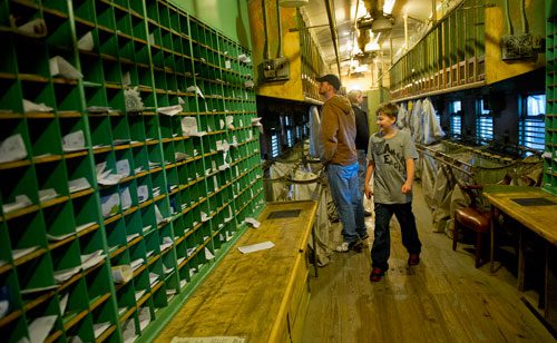 Seth Putnam (right), his father Brian and his uncle Andy Putnam (right) walk through a locomotive mail car at the Southeastern Railway Museum in Duluth on Thursday, January 3, 2013.