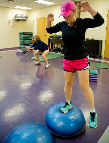 Renee Reddic performs exercises as trainer Shelby Katz demonstrates another exercise during a personal training class at the Robert D. Fowler YMCA in Peachtree Corners on Thursday, December 13, 2012. 