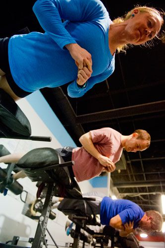 Leah Polaski (top), Chris Schmitz and Jason Parrish perform exercises during a class at CrossFit Atlanta on Thursday, December 13, 2012. 