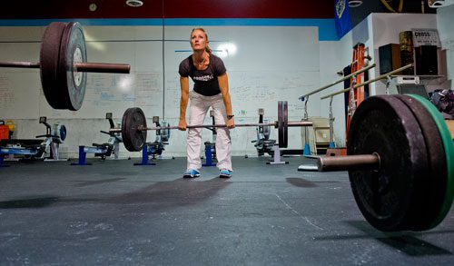 Lisa Teer lifts weights during a class at CrossFit Atlanta on Thursday, December 13, 2012. 