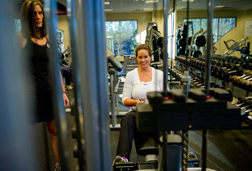 Stacie Sikes (right) works out with trainer Shelby Katz at the Robert D. Fowler YMCA in Peachtree Corners on Friday, December 14, 2012. 