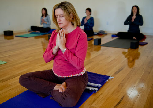 Susan Himmer (center), Christy Aldredge, Patti Sopko and Renee Mango breathe in and try to relax before beginning their class at Plum Tree Yoga in Roswell on Friday, December 14, 2012. 