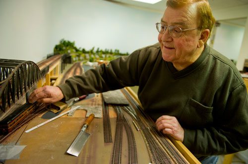 George Bloodworth runs his trial train car over a patch of track at his home in Alpharetta on Sunday, January 6, 2013. 