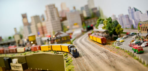 A model train connects cars before it runs around the 360 foot main track at George Bloodworth's home in Alpharetta on Sunday, January 6, 2013.