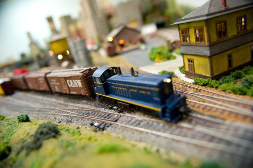 A model train connects cars as it runs around the 360 foot main track at George Bloodworth's home in Alpharetta on Sunday, January 6, 2013.