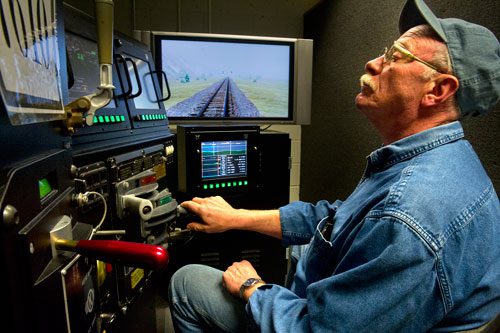 Locomotive engineer trainee Mike Henry operates the controls of an engine simulator at the Norfolk Southern Training Center in McDonough on Friday, January 11, 2013. 