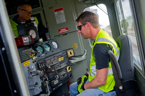 Locomotive engineer trainee Dale Maier (right) talks with instructor Bob Woodruff as he sits at the controls of an engine at the Norfolk Southern Training Center in McDonough on Friday, January 11, 2013. 