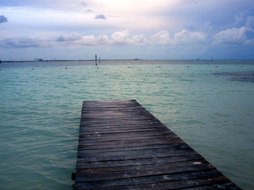 A pier off of Cancun City with Isla Mujeres visible in the background on Thursday, January 24, 2013.