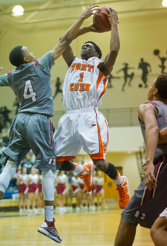 North Cobb's Dennis Young-Coleman (1) tries to get the ball past Hillgrove's Shamari Southwell (4) during the AAAAAA Region 4 championship game on Saturday, February 16, 2013. 