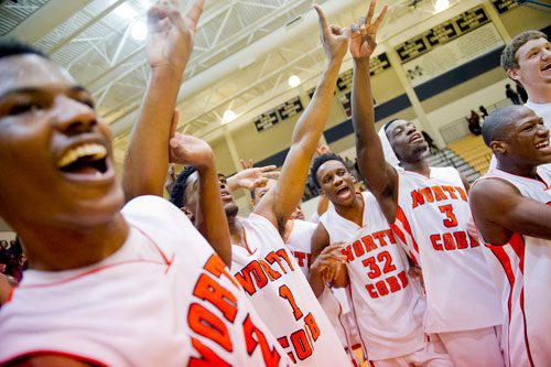 North Cobb's Jon Beausejour (3), Kenny Ume (32), Dennis Young-Coleman (1) and Lee Moore (2) celebrate their AAAAAA Region 4 victory over Hillgrove on Saturday, February 16, 2013. 