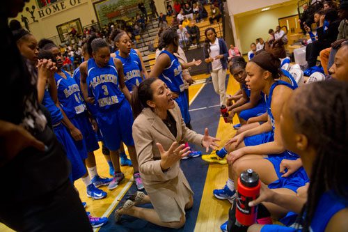 McEachern head coach Phyllis Arthur (center) talks to her players during a timeout in their game against North Cobb for the AAAAAA Region 4 championship on Saturday, February 16, 2013.
