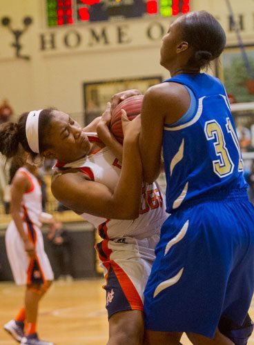 North Cobb's Jordan Gray (left) battles for control of the ball with McEachern's Tierra Lindsey (31) on Saturday, February 16, 2013.
