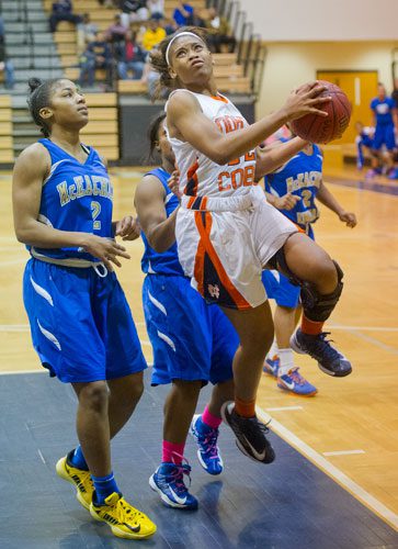 North Cobb's Amber Reeves (right) goes up for two past McEachern's Te'a Cooper (2) on Saturday, February 16, 2013.
