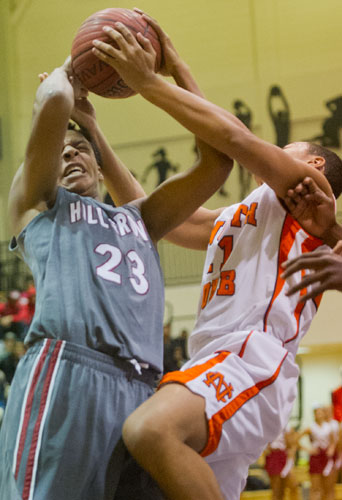 Hillgrove's John Franklin (23) battles with North Cobb's Devin Everage (21) for the rebound on Saturday, February 16, 2013.