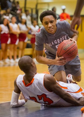 Hillgrove's BJ Brown (5) falls to the court after colliding with North Cobb's Leon Jordan (23) on Saturday, February 16, 2013.
