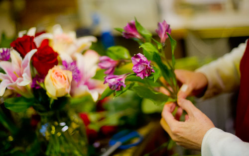 May Tsai arranges flowers in a vase at A Blooming Earth florist shop in Decatur on Thursday, January 31, 2013.