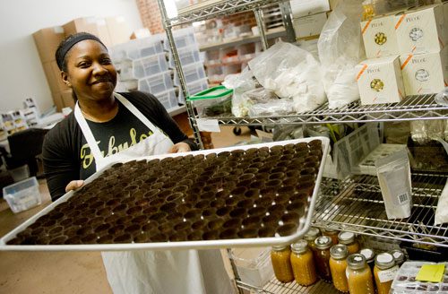 Catreice Garrett carries a tray filled with caramels at Cacao Atlanta in Inman Park on Friday, February 1, 2013.