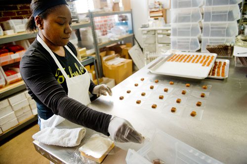 Catreice Garrett wraps individual pieces of caramel at Cacao Atlanta in Inman Park on Friday, February 1, 2013.