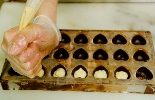 Bianca Garcia fills truffles with white chocolate ganache at Cacao Atlanta in Inman Park on Friday, February 1, 2013.