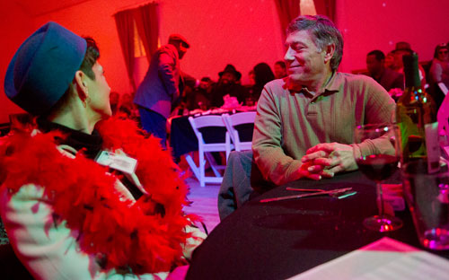 Marcy Stoll (left) and her husband Dave eat dinner as Ismail Conner entertains the crowd during the murder mystery dinner Death at the Doo Wop at Blue Mark Studios in Midtown on Tuesday, February 12, 2013.