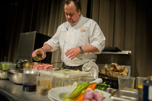 Chef Scott Serpas cooks up a storm during the 2013 Atlanta Chefs Expo at the Georgia World Congress Center in Atlanta on Sunday, February 24, 2013.