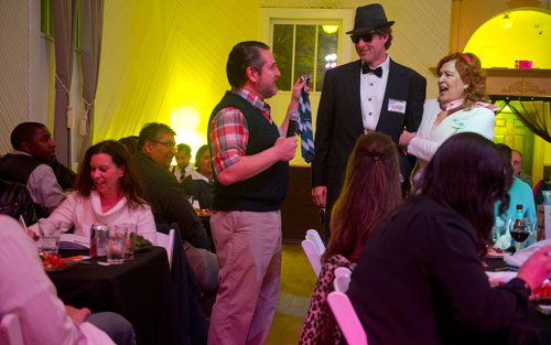  Perry Rintye (left) interviews Coleman Rudolph as he stands next to Virginia Kirby during the murder mystery dinner Death at the Doo Wop at Blue Mark Studios in Midtown on Tuesday, February 12, 2013.