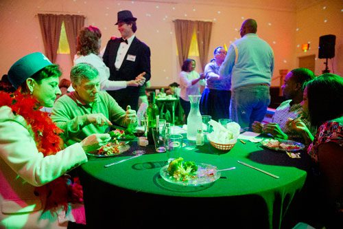 Marcy Stoll (left) and her husband Dave and Emanuel Shaw and Kelita Sherrod eat dinner as Virginia Kirby, Coleman Rudolph, Crystal Black and K.D. Mills dance during the murder mystery dinner Death at the Doo Wop at Blue Mark Studios in Midtown on Tuesday, February 12, 2013. 