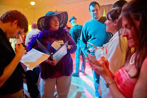 Tracy Stoddard (second left) answers questions as Mike Mobilio (left), Russell Smith, Betsy Leach and Shannon Rudolph interview her as a suspect during the murder mystery dinner Death at the Doo Wop at Blue Mark Studios in Midtown on Tuesday, February 12, 2013. 