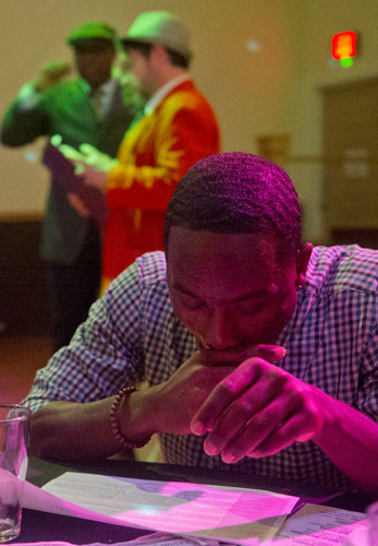 Emanuel Shaw (right) looks over his notes as Perry Rintye and Ismail Conner perform  during the murder mystery dinner Death at the Doo Wop at Blue Mark Studios in Midtown on Tuesday, February 12, 2013. 