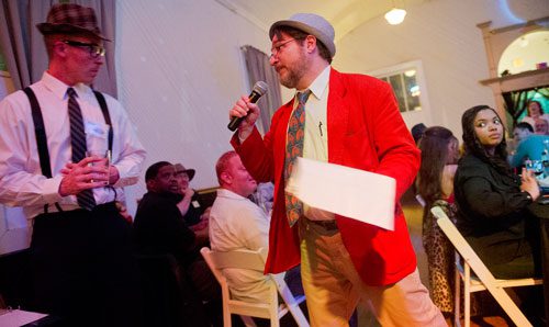  John Cowart (left) is interviewed by Perry Rintye during the murder mystery dinner Death at the Doo Wop at Blue Mark Studios in Midtown on Tuesday, February 12, 2013. 