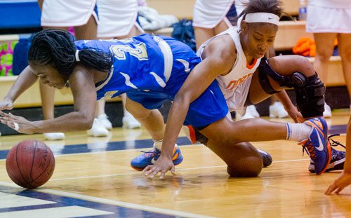 McEachern's Declaria Daniels (24) and North Cobb's Amber Reeves battle for control of the ball as it rolls out of bounds on Saturday, February 16, 2013.
