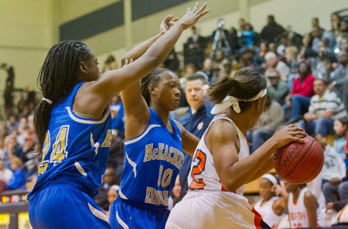 McEachern's Declaria Daniels (24) and Triana Tisdale (00) double team North Cobb's Amber Reeves on Saturday, February 16, 2013.