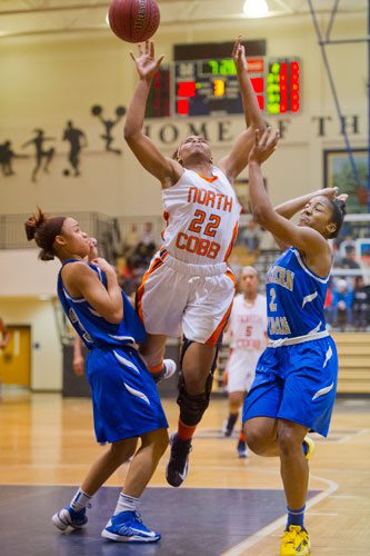 North Cobb's Amber Reeves (22) looses control of the ball as she is double teamed by McEachern's Chynna Ewing (left) and Te'a Cooper (2) on Saturday, February 16, 2013.