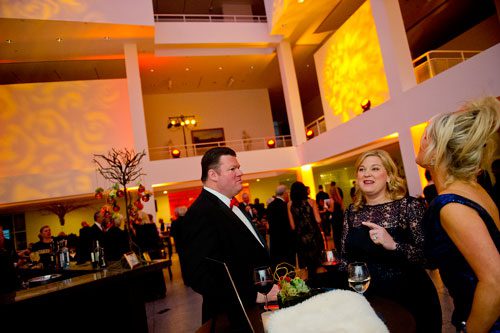 Tad Hutcheson (left) talks with his wife Hanin and Julie Barringer during the third annual Symphony Gala at the Woodruff Arts Center in Atlanta on Saturday, March 2, 2013. 