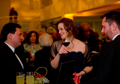 Susan Ambo (center) talks with her husband Stephen (left) and Trevor Ralph during the third annual Symphony Gala at the Woodruff Arts Center in Atlanta on Saturday, March 2, 2013. 