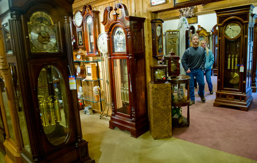 Derry Swan (left) and Shannon Britt look at clocks while walking through Champ's Clock Shop in Douglasville during their fifth annual Chime Event on Saturday, March 9, 2013. 