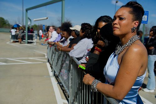 Rhonda Moss (right) waits behind a barricade as she looks for celebrities during the red carpet event for Tyler Perry's new movie Temptation at the AMC Parkway Pointe 15 theaters in Atlanta on Saturday, March 16, 2013. 