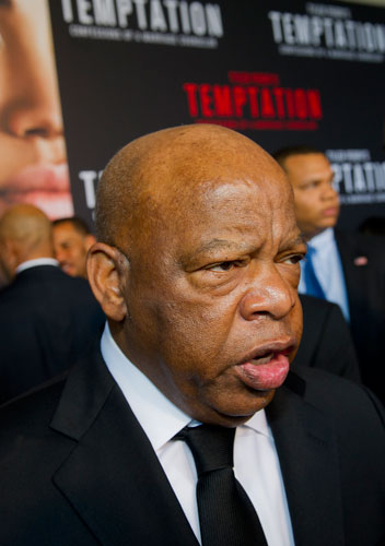 Congressman John Lewis gives an interview as he walks the red carpet for Tyler Perry's new movie Temptation at the AMC Parkway Pointe 15 theaters in Atlanta on Saturday, March 16, 2013. 
