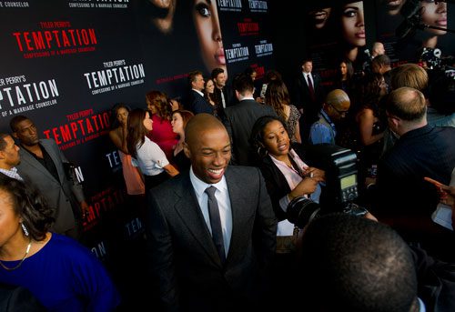 Robbie Jones (center) walks the red carpet for Tyler Perry's new movie Temptation at the AMC Parkway Pointe 15 theaters in Atlanta on Saturday, March 16, 2013. 