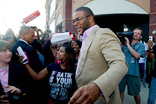 Tyler Perry greets fans before walking the red carpet for his new movie Temptation at the AMC Parkway Pointe 15 theaters in Atlanta on Saturday, March 16, 2013. 