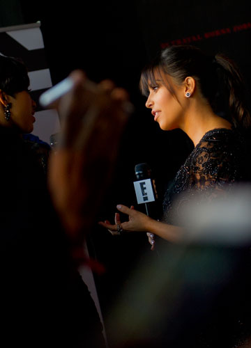 Kim Kardashian (right) gives an interview as she walks the red carpet for Tyler Perry's new movie Temptation at the AMC Parkway Pointe 15 theaters in Atlanta on Saturday, March 16, 2013. 