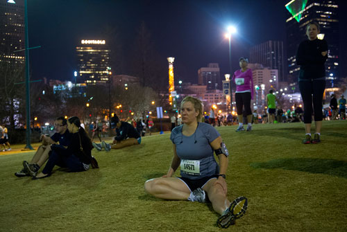 Mary Larson (14571) stretches in Centennial Olympic Park as runners gather for the 2013 Publix Georgia Marathon/Half Marathon in Atlanta on Sunday, March 17, 2013.