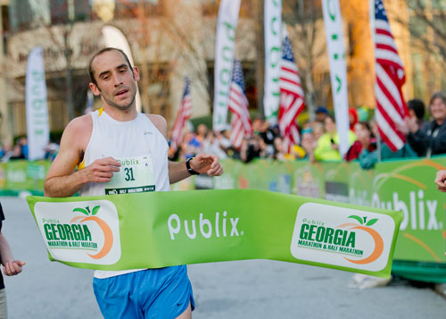 Andrew Heath crosses the finish line winning the half marathon male category with a time of 1:09:55 during the 2013 Publix Georgia Marathon/Half Marathon in Atlanta on Sunday, March 17, 2013. 