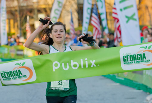 Justyna Mudy crosses the finish line winning the half marathon female category with a time of 1:18:49 during the 2013 Publix Georgia Marathon/Half Marathon in Atlanta on Sunday, March 17, 2013. 