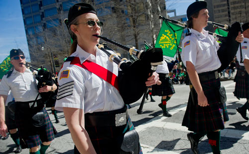Lisa Wight holds her bagpipe as she marches down Peachtree Street during the 131st Atlanta St. Patrick's Day Parade on Saturday March 16, 2013.