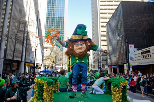 Dressed as a leprechaun, Diego Correa (center) dances and waves to the crowd on Peachtree Street during the 131st Atlanta St. Patrick's Day Parade on Saturday March 16, 2013. 