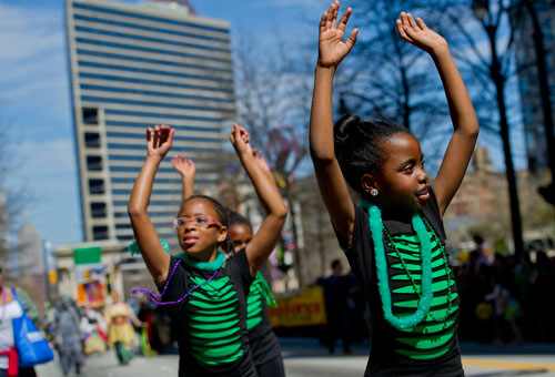 Gabrielle Turner (right) and Kennedy Johnson march down Peachtree Street during the 131st Atlanta St. Patrick's Day Parade on Saturday March 16, 2013.