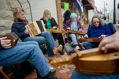 Denise Womack (left), Gwen Caeli, Carol Downs and Pam Deemer perform on Main Street during the Stone Mountain Village Blue Grassroots Music and Arts Festival on Saturday, March 23, 2013. 